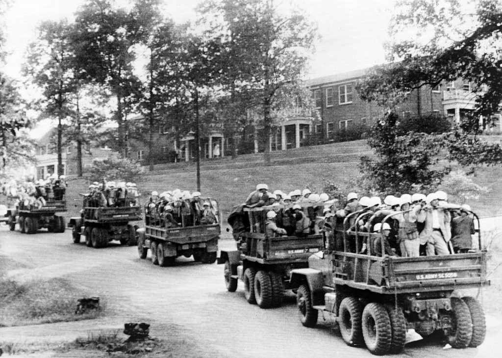 U.S. Army trucks loaded with steel-helmeted federal agents roll across the University of Mississippi campus on October 3, 1962.