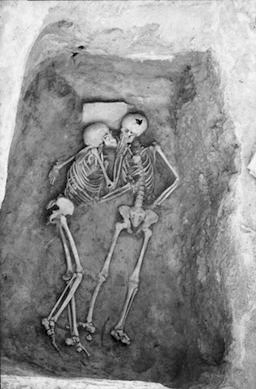 Hasanlu Lovers - Photo named "The Lovers" by Penn Museum and depicting skeletal remains uncovered at the Hasanlu archaeological site in Iran.