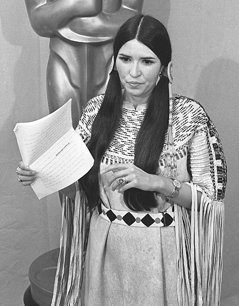 Sacheen Littlefeather standing before the Oscar statue holding Marlon Brando's statement at the 45th annual Academy Awards in Los Angeles.