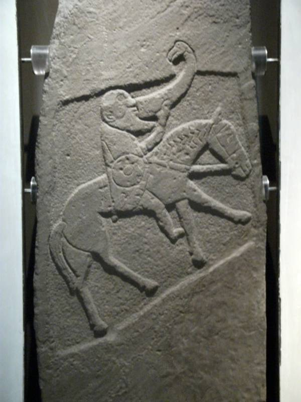 A depiction of a Pictish horseman indulging in a drink while mounted on a horse.