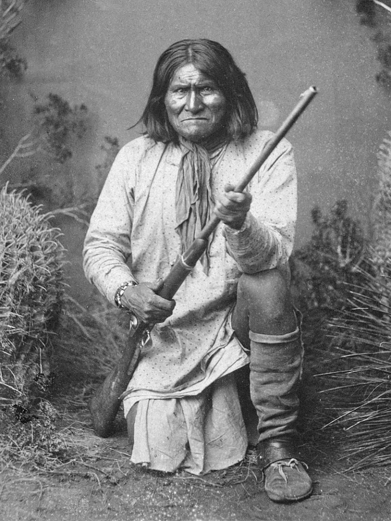 Geronimo kneeling with rifle