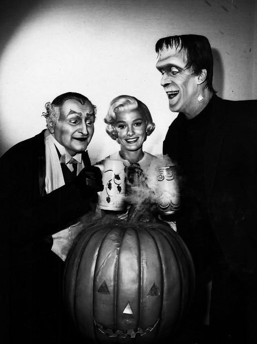 Gwynne (right) as Herman Munster, sharing a toast with Al Lewis (Grandpa) while Beverley Owen (Marilyn) looks on